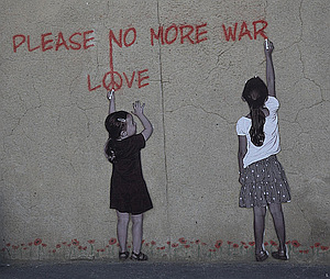 Mural of two young girls writing "PLEASE NO MORE WAR" "LOVE" on a wall