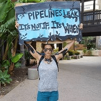 Person holding sign: Pipelines Leak, It's Not If, It's When