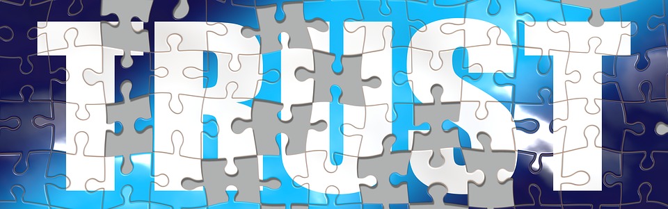 A jigsaw puzzle depicting the word "TRUST"